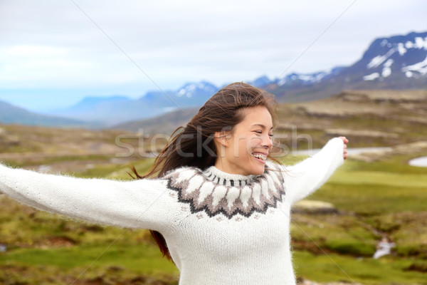 Happy free woman on Iceland in Icelandic sweater Stock photo © Maridav