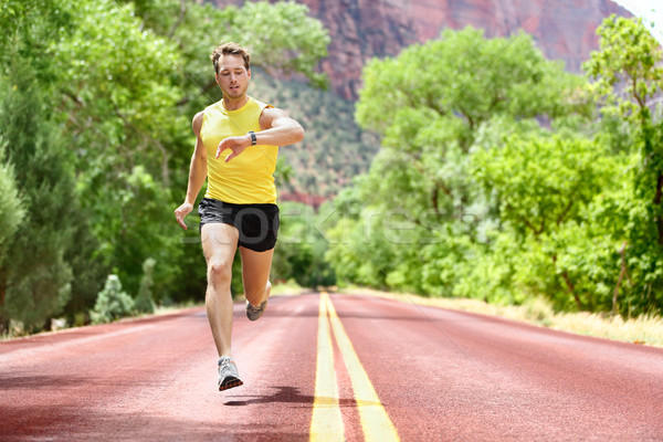 Running man looking heart rate monitor smartwatch Stock photo © Maridav