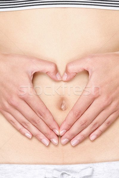 Kezek szív gyomor köldök egészséges emésztés Stock fotó © Maridav