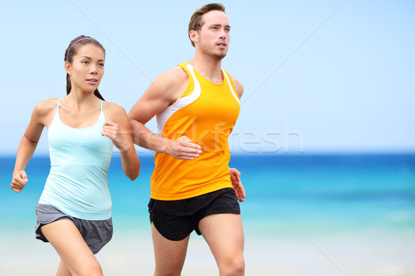 Runners running on beach - jogging couple Stock photo © Maridav