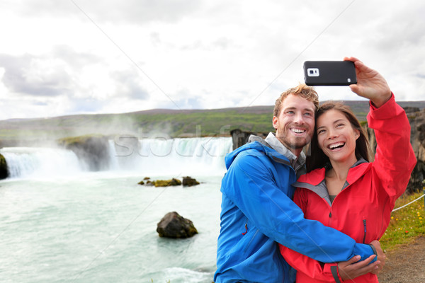 Selfie couple taking smartphone picture waterfall Stock photo © Maridav