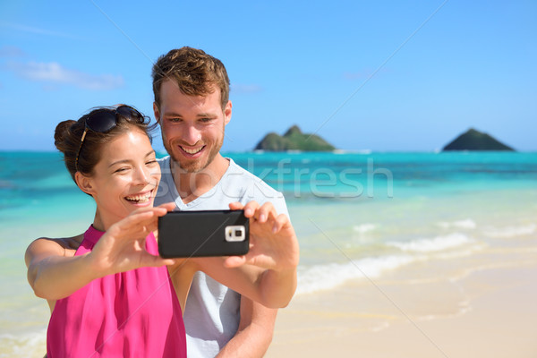 Beach vacation couple taking selfie on smartphone Stock photo © Maridav