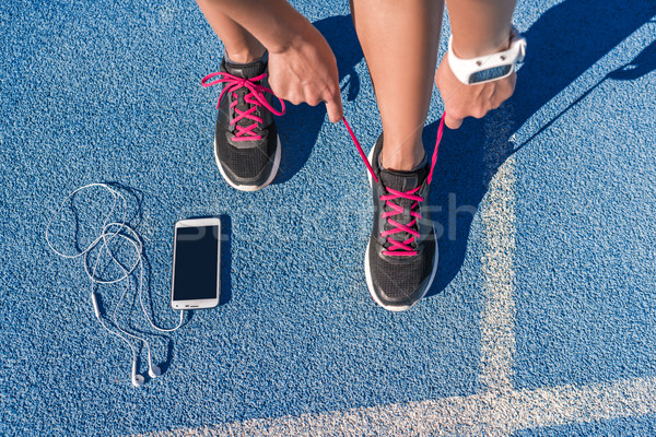 Runner tying running shoes laces on race run track Stock photo © Maridav