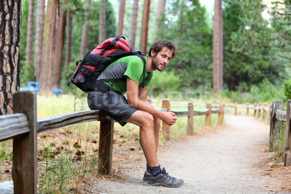 Hiking man resting with backpack in forest park Stock photo © Maridav