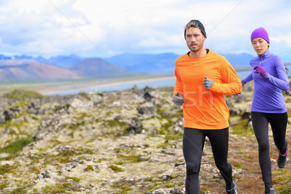 Trail runner man and woman running cross-country Stock photo © Maridav