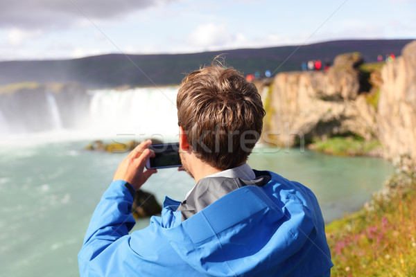 Tourist taking photo of waterfall Godafoss Iceland Stock photo © Maridav