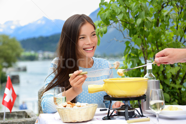People eating Swiss cheese fondue having dinner Stock photo © Maridav