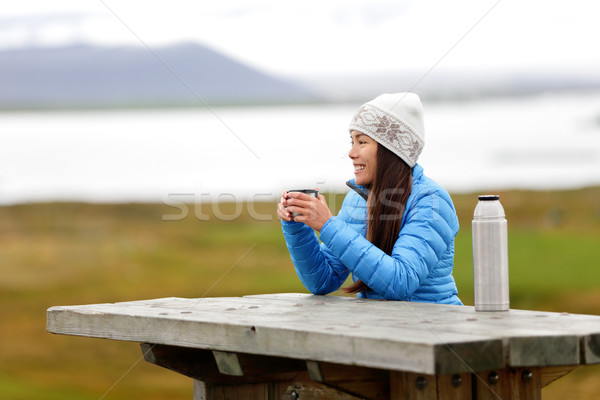 Woman in outdoors drinking coffee from thermos Stock photo © Maridav