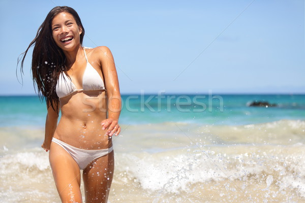 People having summer beach fun - woman in water Stock photo © Maridav