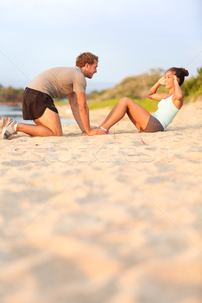 Sit ups fitness woman - male helping happy smiling Stock photo © Maridav