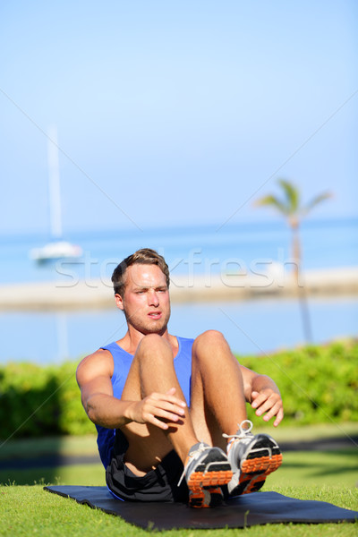 Training fitness man doing sit-ups exercise Stock photo © Maridav