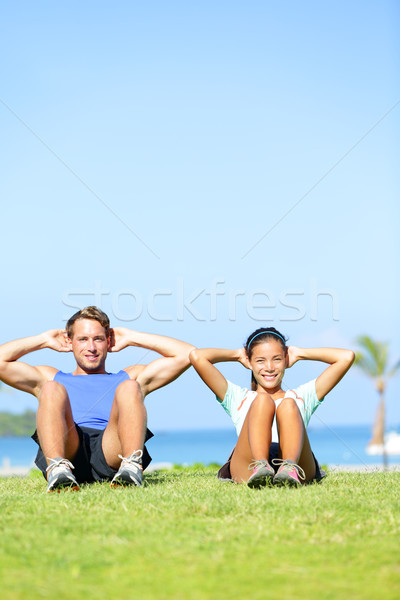 People exercising - Couple doing sit ups outdoors Stock photo © Maridav