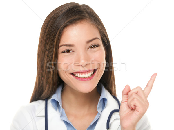 Doctor pointing - or female nurse showing Stock photo © Maridav