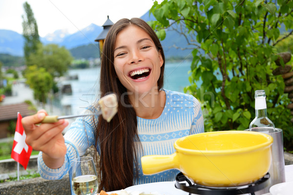 Swiss cheese fondue - woman eating laughing Stock photo © Maridav