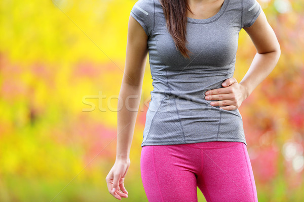 Side cramps - woman runner side stitch Stock photo © Maridav