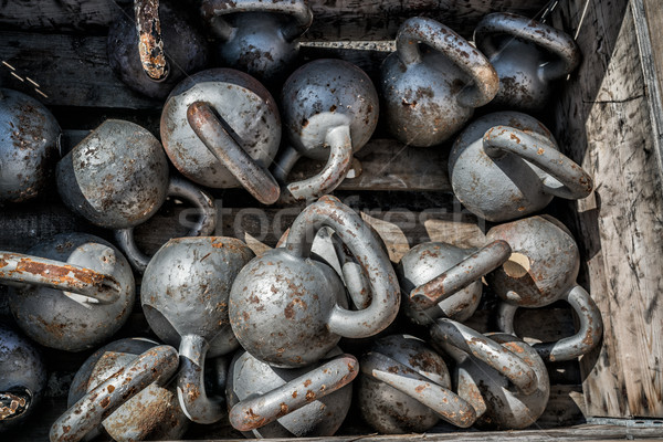 Many kettlebells weights background at fitness gym Stock photo © Maridav