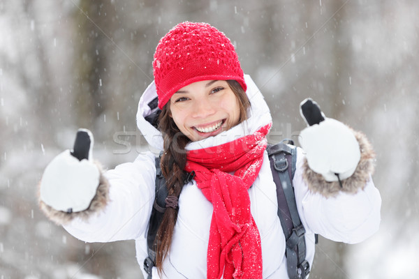 Happy woman in snowstorm giving thumbs up Stock photo © Maridav
