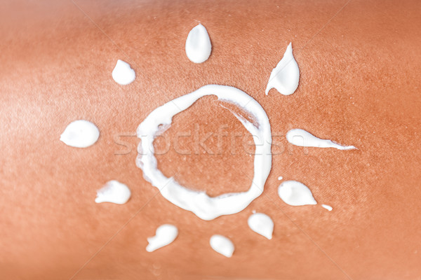 Sunscreen tan lotion sun drawing in cream on skin Stock photo © Maridav