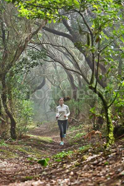 Runner woman cross-country running in forest Stock photo © Maridav