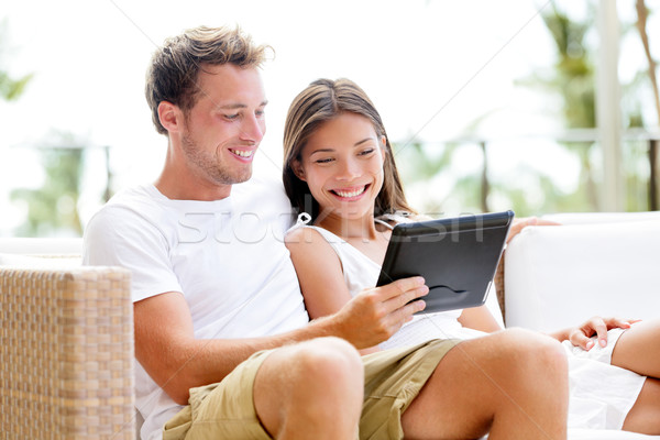 Couple relaxing together in sofa with tablet pc Stock photo © Maridav