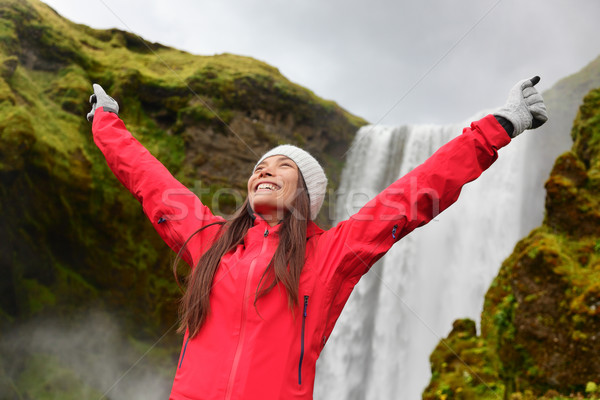 Happy woman by waterfall Skogafoss on Iceland Stock photo © Maridav