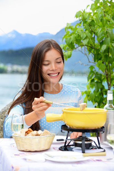 Cheese fondue - woman eating Swiss food Stock photo © Maridav