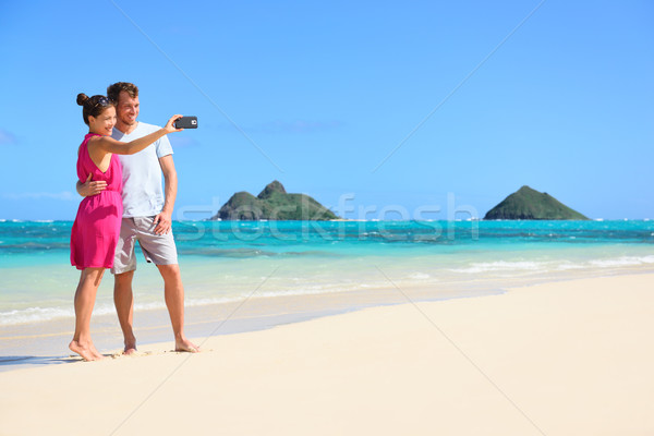 Couple on beach vacation taking selfie smartphone Stock photo © Maridav