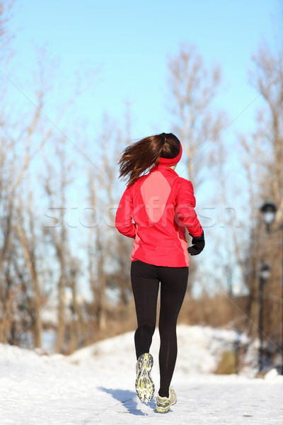 Winter running woman in snow Stock photo © Maridav