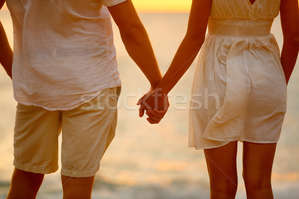 Romantic couple holding hands on beach sunset Stock photo © Maridav