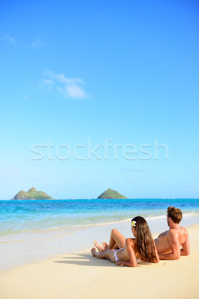 Beach vacations suntan couple relaxing in Hawaii Stock photo © Maridav