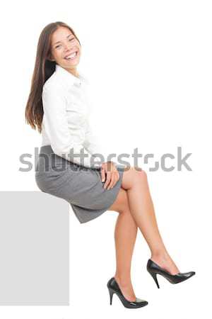 Business woman sitting on blank sign Stock photo © Maridav