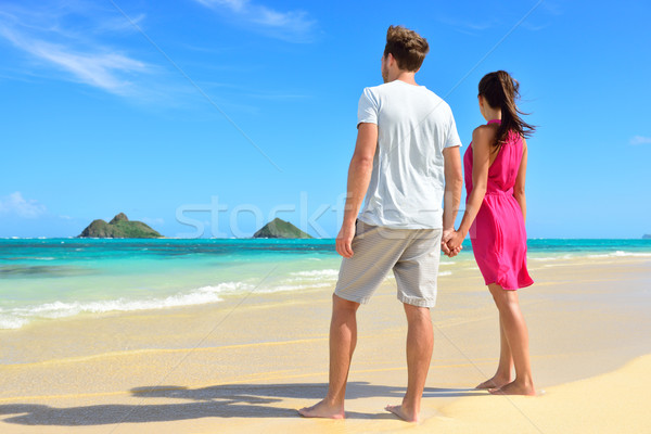 Beach couple looking at ocean view from behind Stock photo © Maridav