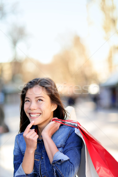 Shopping woman thinking looking up outdoors Stock photo © Maridav