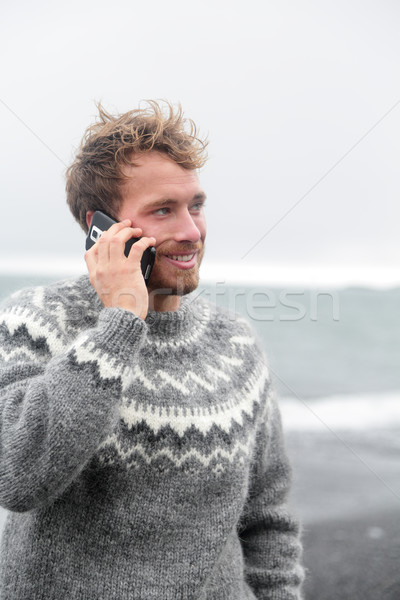 Smartphone man talking on phone on beach, Iceland Stock photo © Maridav