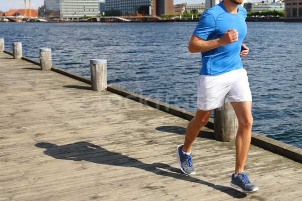 Low Section Of Man Jogging On Boardwalk By River Stock photo © Maridav
