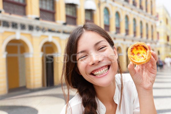 Local Macau food - woman showing Pastel de nata Stock photo © Maridav
