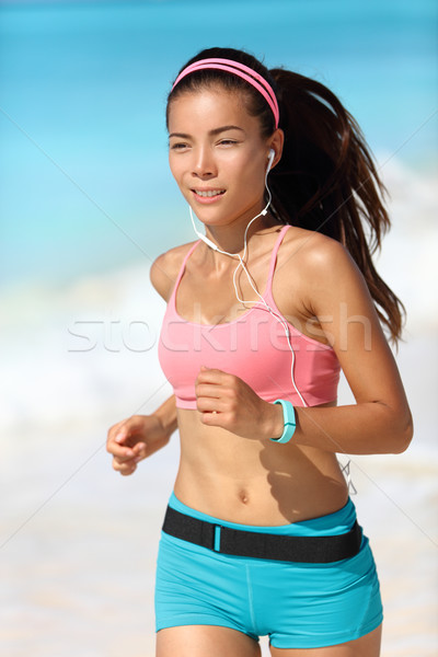 Running woman with earphones and fitness watch Stock photo © Maridav