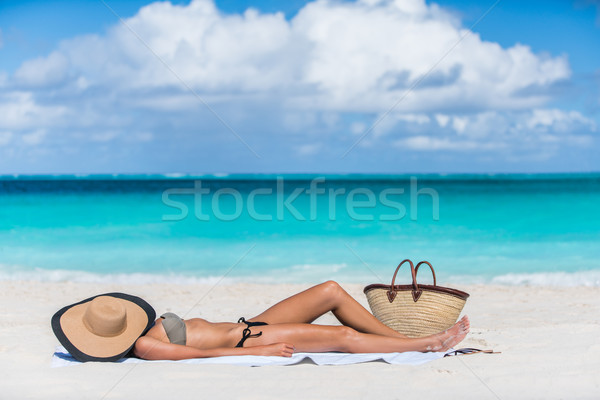 Beach sexy woman tanning with hat protecting face Stock photo © Maridav