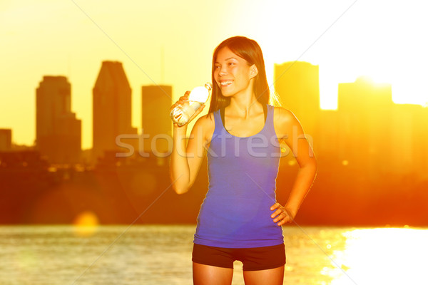 Fitness runner drinking water after city running Stock photo © Maridav