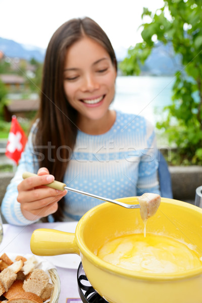 Cheese fondue - woman eating Swiss food Stock photo © Maridav