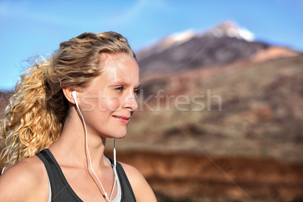 Running woman with earphones - runner portrait Stock photo © Maridav