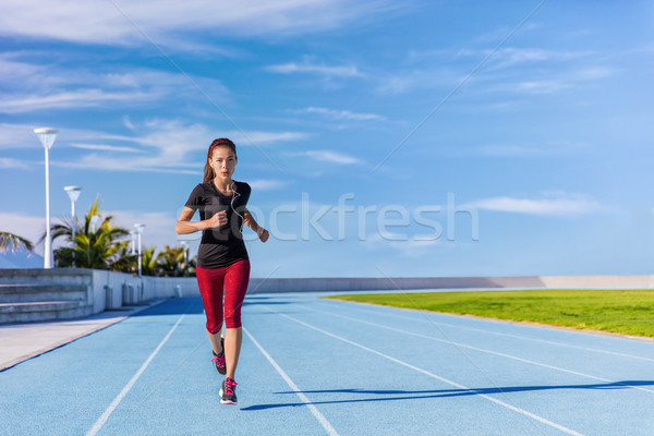 Athlete runner running on outdoor stadium tracks Stock photo © Maridav