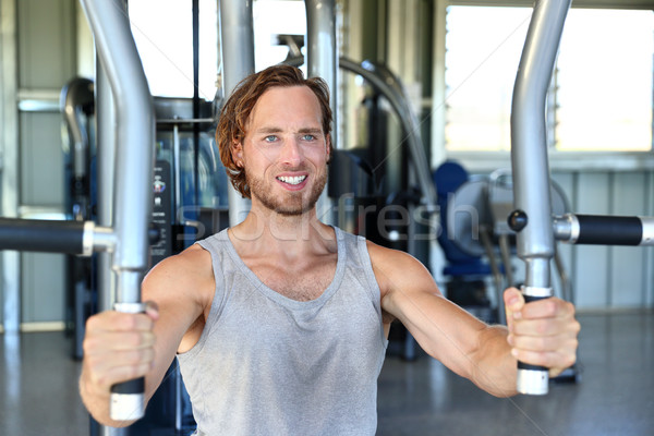 Man strength training hard at fitness gym center Stock photo © Maridav