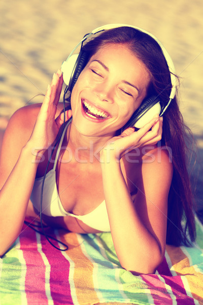 Woman listening to music with headphones at beach Stock photo © Maridav