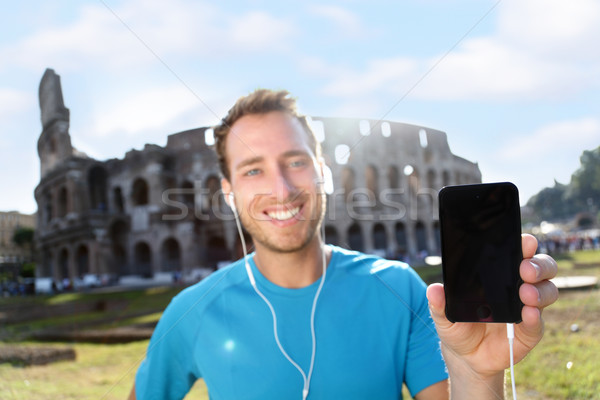 Szczęśliwy uprawiający jogging smartphone młodych Zdjęcia stock © Maridav