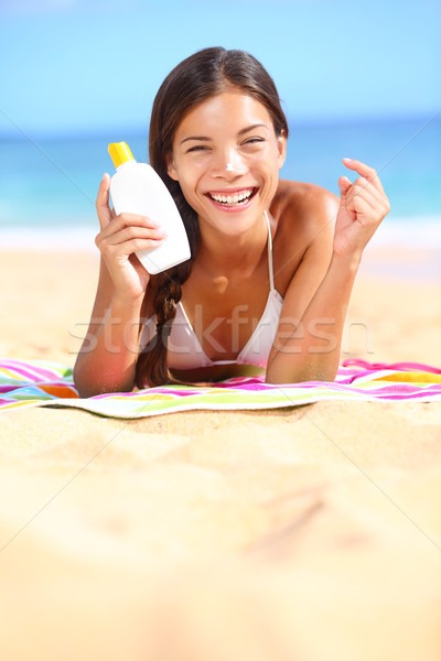 Sunscreen woman showing suntan lotion bottle Stock photo © Maridav