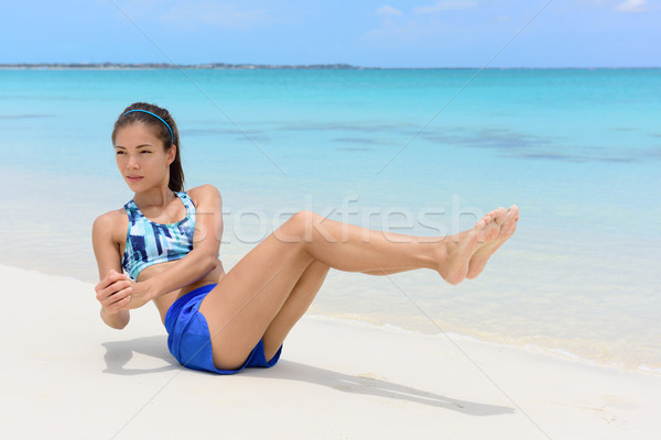 Abs workout - fitness woman working out on beach Stock photo © Maridav