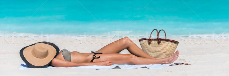 Beach sexy woman tanning with hat protecting face Stock photo © Maridav