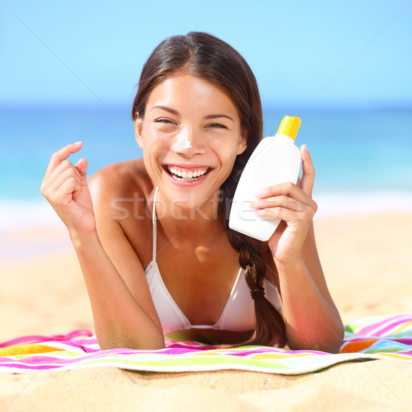 Sunscreen woman applying suntan lotion Stock photo © Maridav