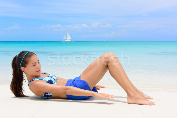 Fitness woman training abs heel touches Stock photo © Maridav